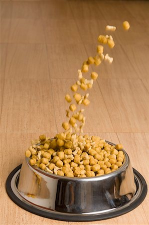 dog pets group - Close-up of dog food being poured in a dog bowl Stock Photo - Premium Royalty-Free, Code: 630-01709723