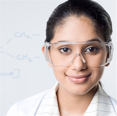 Portrait of a female lab technician wearing a protective eyewear Stock Photo - Premium Royalty-Free, Code: 630-01709919
