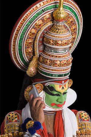 simsearch:857-03553639,k - Close-up of a Kathakali dance performer talking on a mobile phone Stock Photo - Premium Royalty-Free, Code: 630-01709966