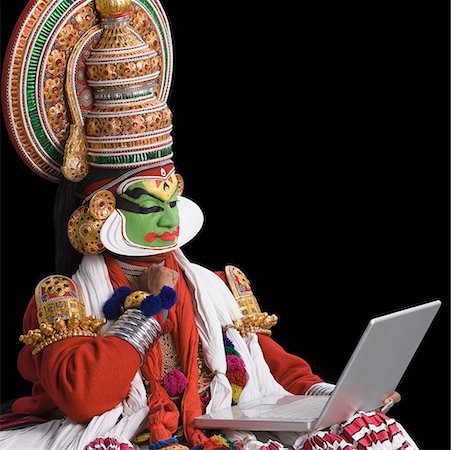 simsearch:857-03553638,k - Close-up of a Kathakali dance performer using a laptop Stock Photo - Premium Royalty-Free, Code: 630-01709963