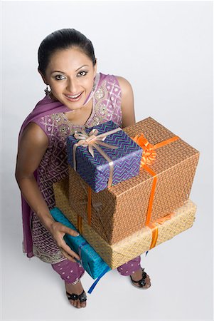 High angle view of a mid adult woman holding a stack of gift boxes Stock Photo - Premium Royalty-Free, Code: 630-01710009