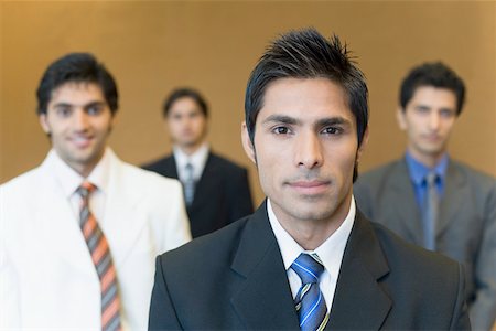 Portrait of a businessman with three business executives standing behind him Stock Photo - Premium Royalty-Free, Code: 630-01874017