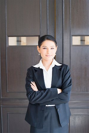 portrait and woman and closeup and arms - Portrait of a businesswoman standing with her arms crossed Stock Photo - Premium Royalty-Free, Code: 630-01874047