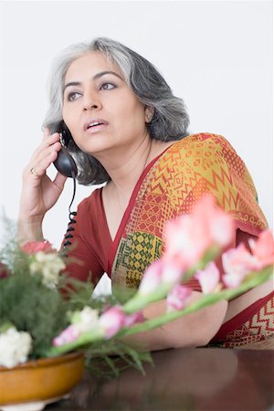 simsearch:630-01877587,k - Close-up of a businesswoman talking on a conference phone Stock Photo - Premium Royalty-Free, Code: 630-01874053