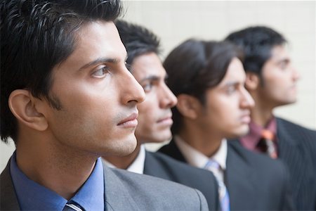 Four businessmen in a row Stock Photo - Premium Royalty-Free, Code: 630-01874128