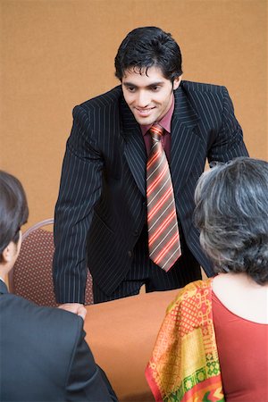 Businessman discussing with two business executives in a meeting Stock Photo - Premium Royalty-Free, Code: 630-01874141