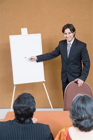 simsearch:630-01874237,k - Businessman giving presentation in a meeting Stock Photo - Premium Royalty-Free, Code: 630-01874142