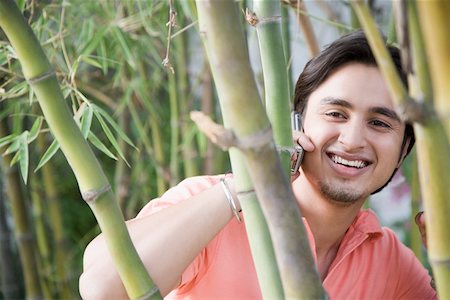 simsearch:630-01079908,k - Close-up of a young man talking on a mobile phone and smiling Stock Photo - Premium Royalty-Free, Code: 630-01874179