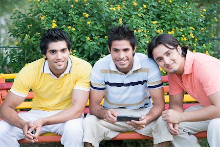 simsearch:630-01128006,k - Portrait of a three young men sitting on the bench and smiling Stock Photo - Premium Royalty-Free, Code: 630-01874188