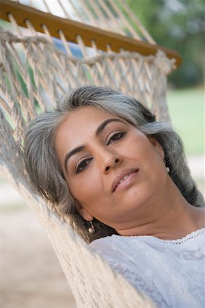 Portrait of a mature woman lying in a hammock Stock Photo - Premium Royalty-Free, Code: 630-01874234