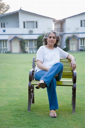 Portrait of a mature woman sitting on the bench Stock Photo - Premium Royalty-Free, Code: 630-01874238