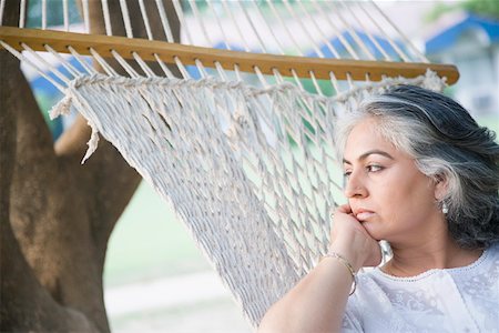 Close-up of a mature woman lying in a hammock Stock Photo - Premium Royalty-Free, Code: 630-01874231