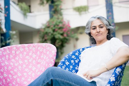 Portrait of a mature woman sitting in an armchair Stock Photo - Premium Royalty-Free, Code: 630-01874255