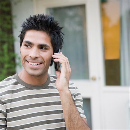 simsearch:630-01079908,k - Close-up of a young man talking on a mobile phone and smiling Stock Photo - Premium Royalty-Free, Code: 630-01874264