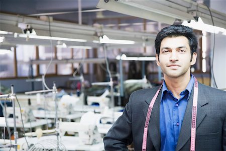 designer indian garment - Portrait of a male fashion designer standing in a textile industry Stock Photo - Premium Royalty-Free, Code: 630-01874305