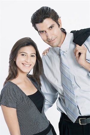 simsearch:630-01874345,k - Portrait of a young couple standing together and smiling Foto de stock - Sin royalties Premium, Código: 630-01874354