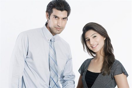 Portrait of a young couple standing together and smiling Stock Photo - Premium Royalty-Free, Code: 630-01874356