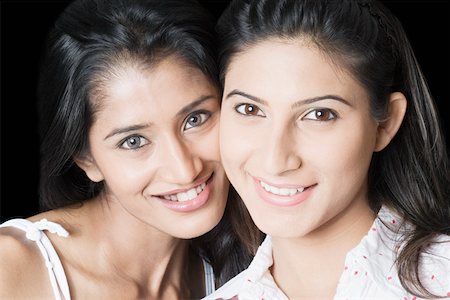 friends black background - Portrait of two young women smiling Stock Photo - Premium Royalty-Free, Code: 630-01874380