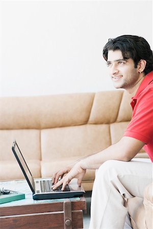 simsearch:630-01128257,k - Side profile of a young man using a laptop Stock Photo - Premium Royalty-Free, Code: 630-01874605