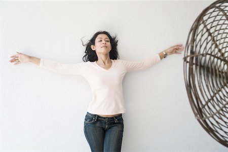 Young woman leaning against a wall Stock Photo - Premium Royalty-Free, Code: 630-01874716