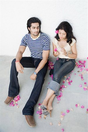 High angle view of a young couple sitting on the floor Stock Photo - Premium Royalty-Free, Code: 630-01874850