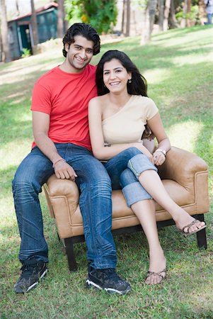 simsearch:630-01874237,k - Portrait of a young couple sitting in an armchair in a park and smiling Stock Photo - Premium Royalty-Free, Code: 630-01874882