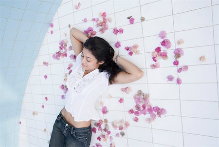 simsearch:630-01873035,k - High angle view of a young woman lying on the floor with her hands behind her head Stock Photo - Premium Royalty-Free, Code: 630-01874947