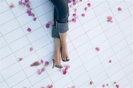 Low section view of a woman's legs on the tiled floor Stock Photo - Premium Royalty-Free, Code: 630-01874941