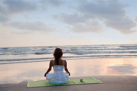sitting yoga pose outside - Rear view of a young woman meditating on the beach Stock Photo - Premium Royalty-Free, Code: 630-01875201