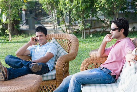 friends talking sofa and two people - Two young men sitting in a lawn Stock Photo - Premium Royalty-Free, Code: 630-01875399