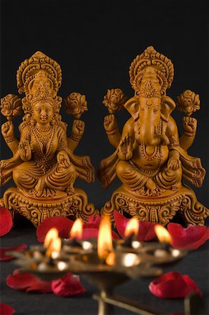 picture of god and goddess - Close-up of an oil lamp burning in front of religious idols Stock Photo - Premium Royalty-Free, Code: 630-01875732