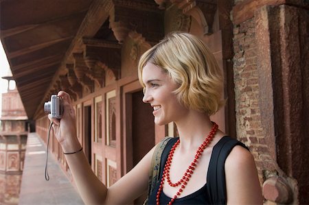 Close-up of a young woman taking a picture with a digital camera, Taj Mahal, Agra, Uttar Pradesh, India Stock Photo - Premium Royalty-Free, Code: 630-01876330
