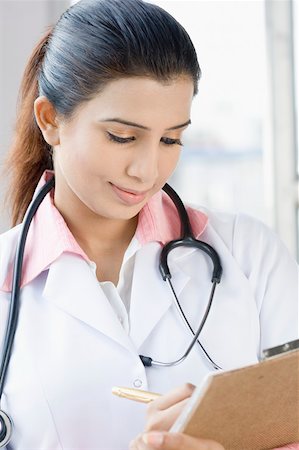 Female doctor holding a clipboard Stock Photo - Premium Royalty-Free, Code: 630-01876392