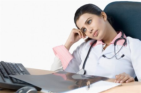 doctor business computer - Close-up of a female doctor thinking in an office Stock Photo - Premium Royalty-Free, Code: 630-01876405