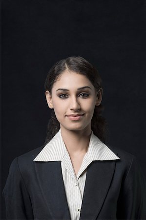 eye contact and camera - Portrait of a businesswoman smirking Stock Photo - Premium Royalty-Free, Code: 630-01876497