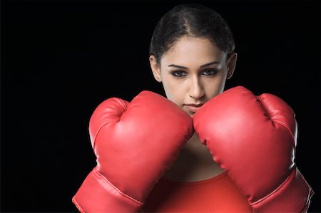 Portrait of a young woman wearing boxing gloves Stock Photo - Premium Royalty-Free, Code: 630-01876571