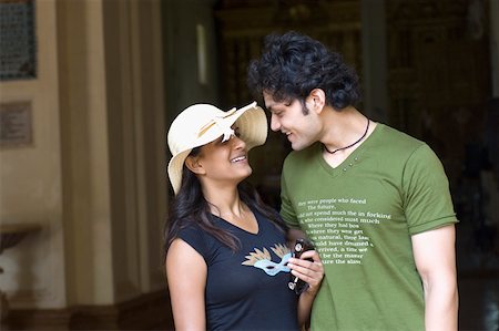 Young couple looking at each other and smiling, Goa, India Stock Photo - Premium Royalty-Free, Code: 630-01876656