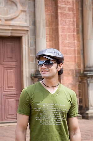 Young man smiling in front of a building, Goa, India Stock Photo - Premium Royalty-Free, Code: 630-01876653