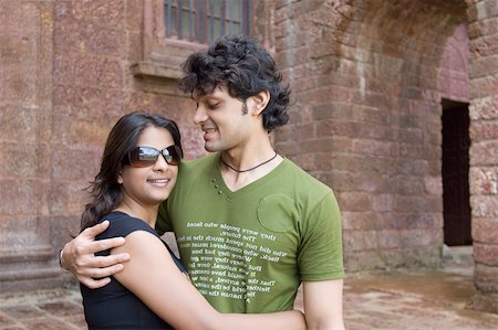 simsearch:630-01876696,k - Young couple embracing each other and smiling, Goa, India Fotografie stock - Premium Royalty-Free, Codice: 630-01876687