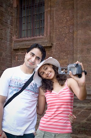 Young couple making a film of themselves with a home video camera, Goa, India Stock Photo - Premium Royalty-Free, Code: 630-01876689