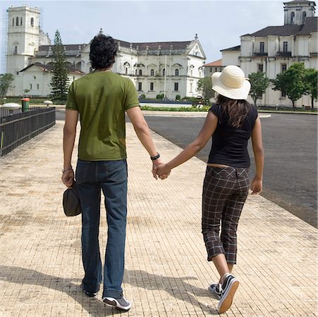 simsearch:630-03481490,k - Rear view of a young couple walking with holding hands, Se Cathedral, Goa, India Stock Photo - Premium Royalty-Free, Code: 630-01876690