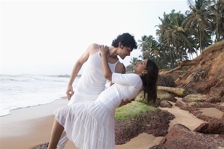 Young couple romancing on the beach, Goa, India Stock Photo - Premium Royalty-Free, Code: 630-01876729