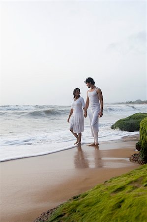 Young couple walking on the beach with holding hands Stock Photo - Premium Royalty-Free, Code: 630-01876736