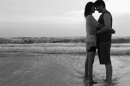 simsearch:630-01876927,k - Side profile of a young couple standing on the beach and embracing each other Stock Photo - Premium Royalty-Free, Code: 630-01876940