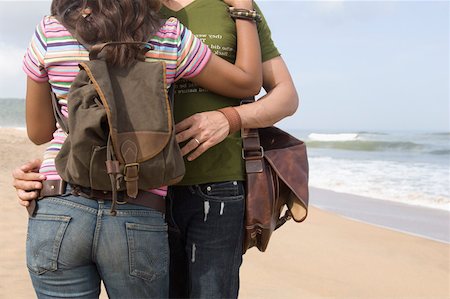 Mid section view of a couple embracing each other on the beach Stock Photo - Premium Royalty-Free, Code: 630-01876977