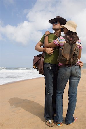 rear photos blue jeans - Young couple standing on the beach and embracing each other Stock Photo - Premium Royalty-Free, Code: 630-01876978