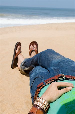 Low section view of a man lying on the beach Stock Photo - Premium Royalty-Free, Code: 630-01877028