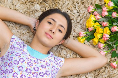 Portrait of a young woman with her hands behind her head Stock Photo - Premium Royalty-Free, Code: 630-01877124