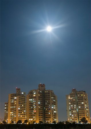 scenes of moon in night - Low angle view of building lit up at night in a city Stock Photo - Premium Royalty-Free, Code: 630-01877146