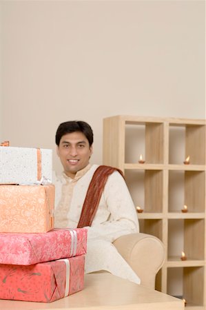 simsearch:630-01877328,k - Gift on a table in front of a young man Stock Photo - Premium Royalty-Free, Code: 630-01877207